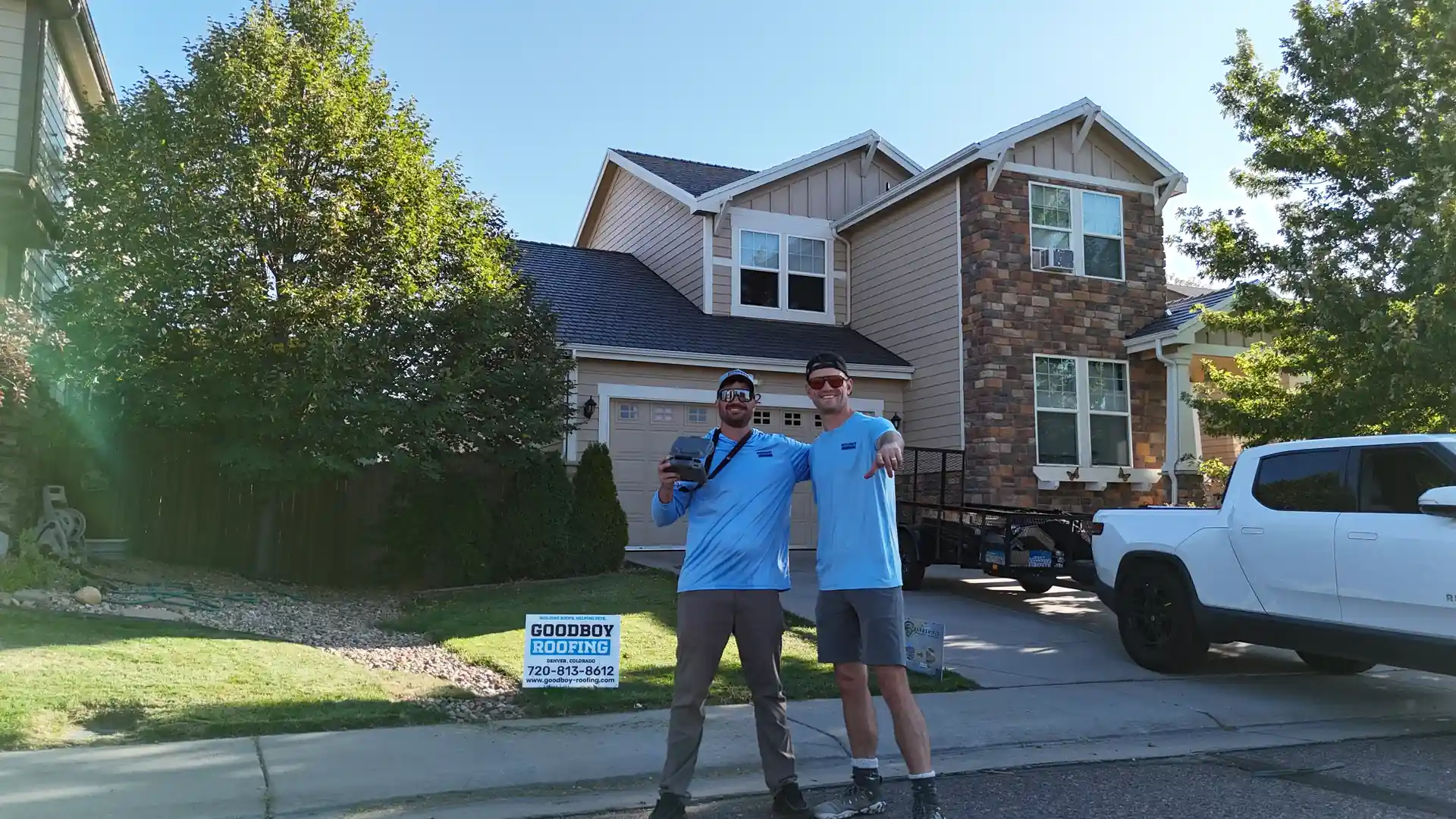 GoodBoy Roofing team in front of a client home