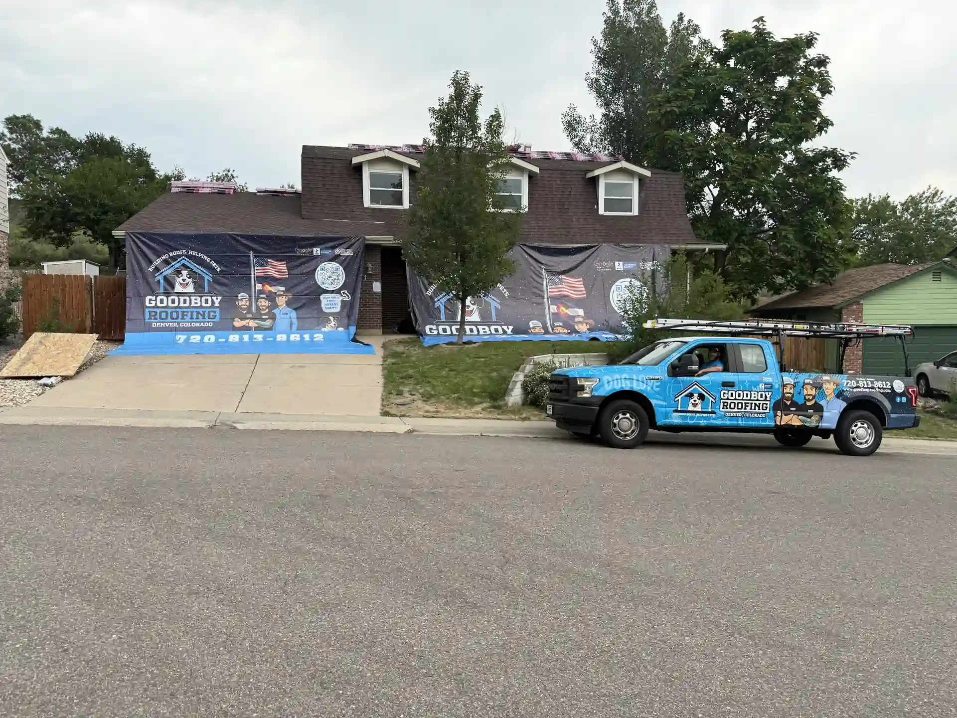 GoodBoy Roofing truck onsite with Catch-All protection around a home